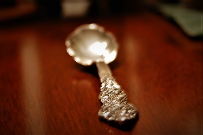 polished sterling silver spoon on table